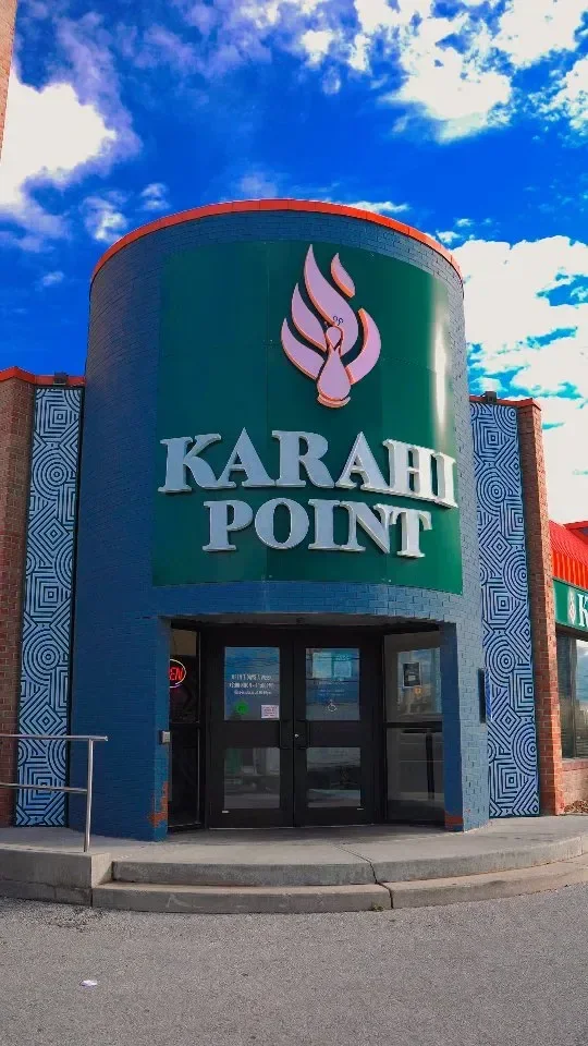 Karahi Point storefront: a round tower carrying the Karahi Point sign under a blue sky